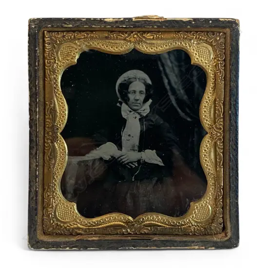 Gilt framed and leather cased ambrotype - seated woman with crossed hands,